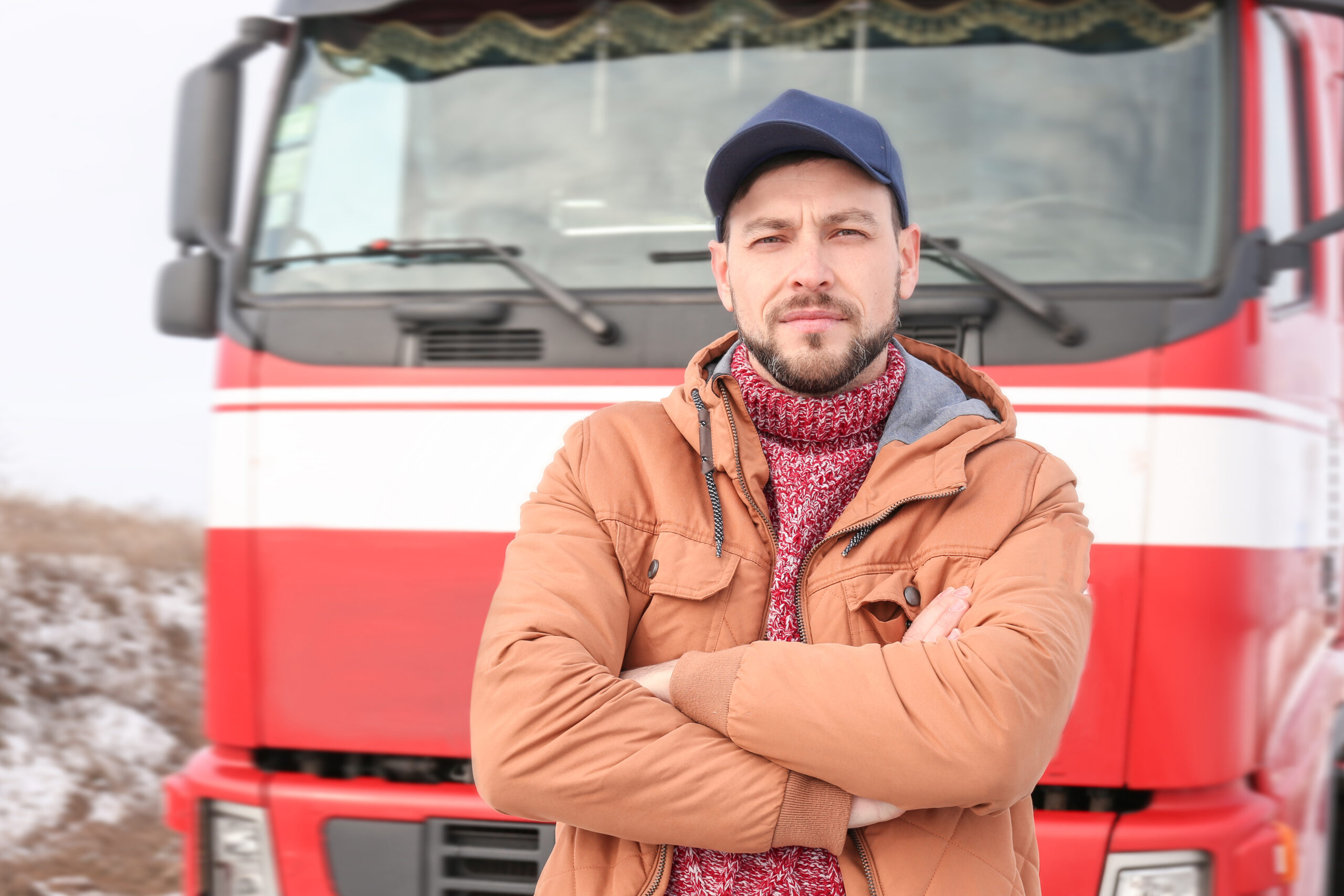 Handsome driver near big modern truck outdoors